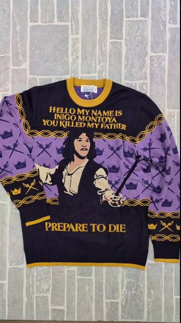 Hello. My name is Inigo Montoya. Prepare for compliments. This exclusive Inigo Montoya Princess Bride Adult Sweater lets you channel the iconic swordsman with cozy style and fan-favorite flair. Great for movie nights, Halloween, or just making a bold statement at sweater parties!